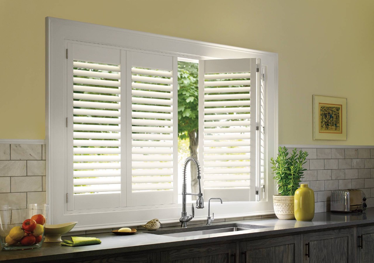  Hunter Douglas Palm Beach™ Polysatin™ Vinyl Shutters Above a Kitchen Sink near O’Fallon, MO