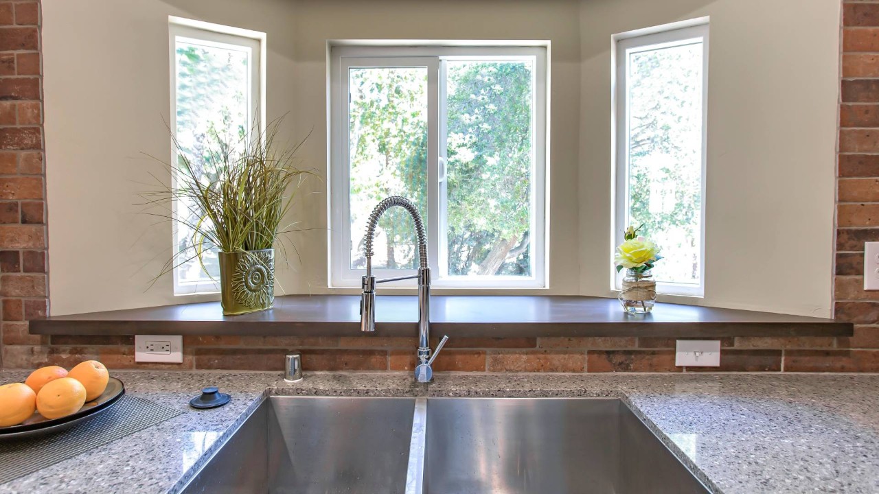 A bay window behind a kitchen sink and counter space at All About Blinds, Etc. near O Fallon, MO