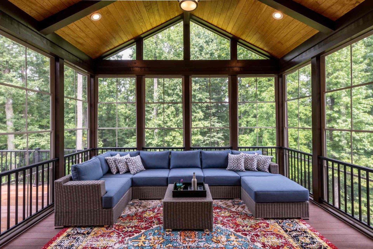 An enclosed patio with windows and water-resistant furniture at All About Blinds, Etc. near O'Fallon, Missouri